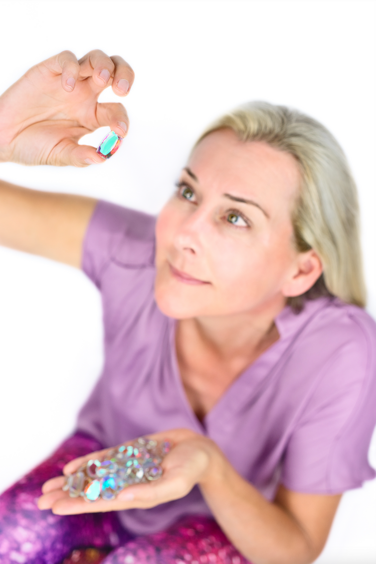 Brit Cooper holding a sparkling crystal up to the light