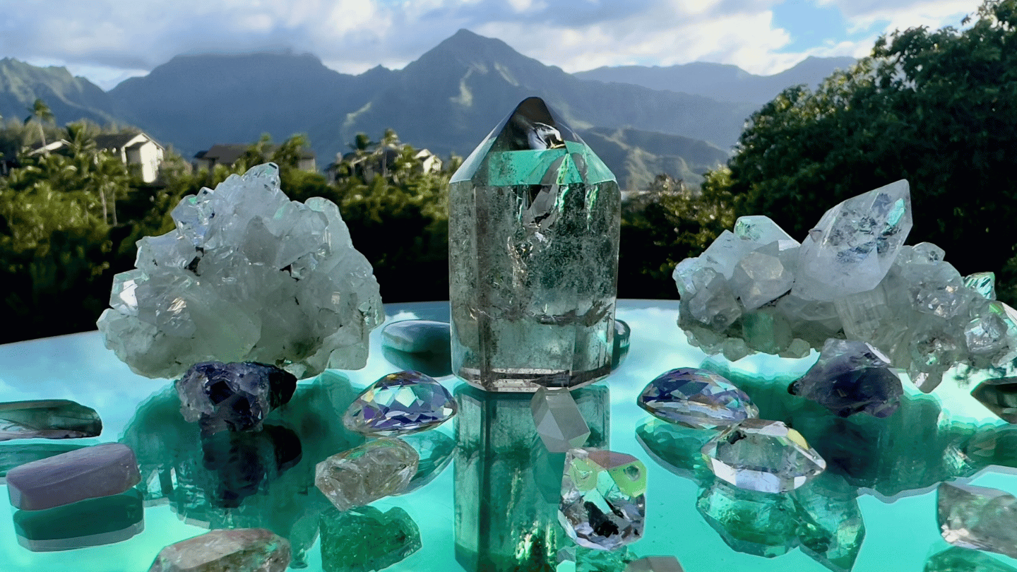 Crystal Grid formations on a table with Kauai landscape in the background. Sparkle Style® Kauai, HI